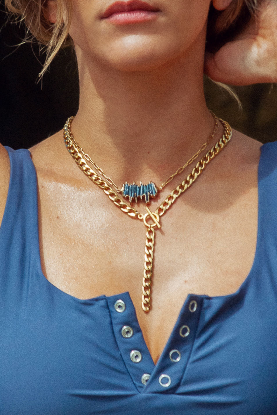 Unleash Edge with Aubrey Necklace. Stacked blue kyanite shard stones create a unique, eye-catching piece. Pendant measures 1.25 inch on a paperclip chain.