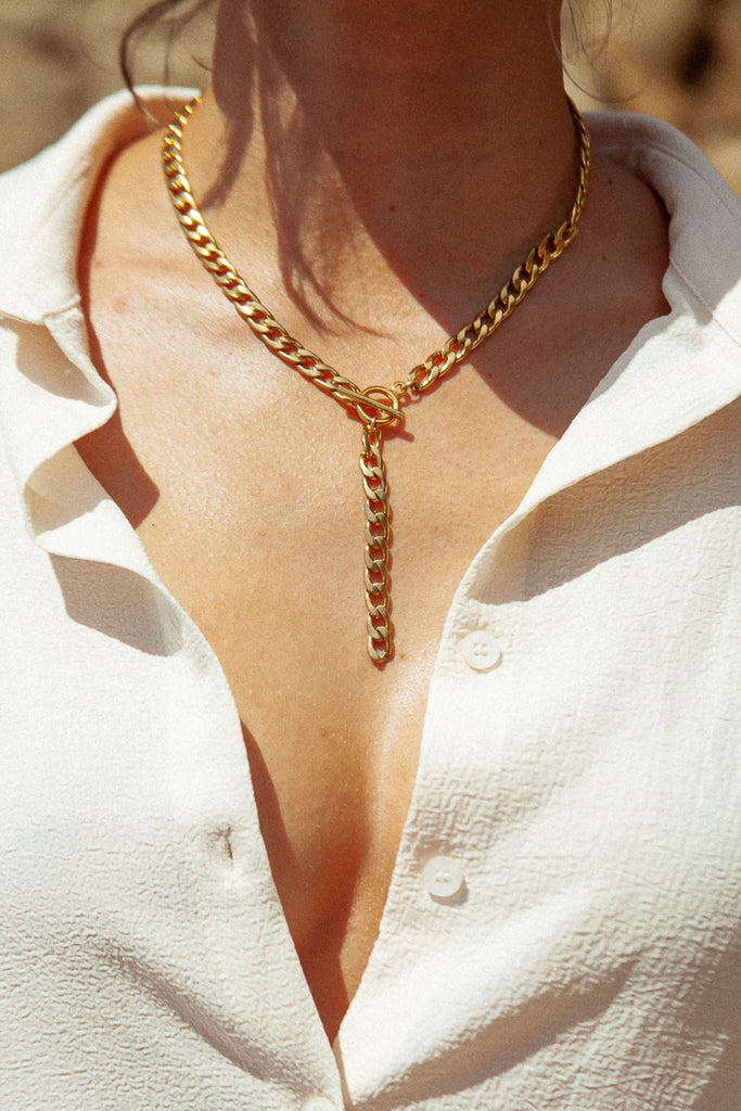 Lucy y-shaped necklace: Stylish and sexy with front toggle closure. Made of 1/4 inch wide flat curb chain and 3 inch hanging chain. A statement piece.