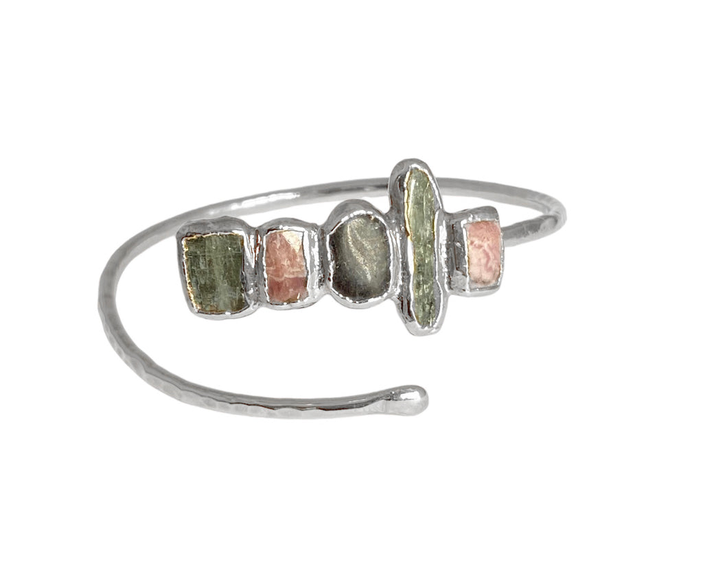 Enhance any occasion with this Lincoln bracelet. Its adjustable design and hand-hammered detailing make it unique, while the Rhodochrocite, Labradorite, and kyanite stones add a captivating touch. Enjoy a touch of luxury with a stunning 1.25-inch cluster of stones!