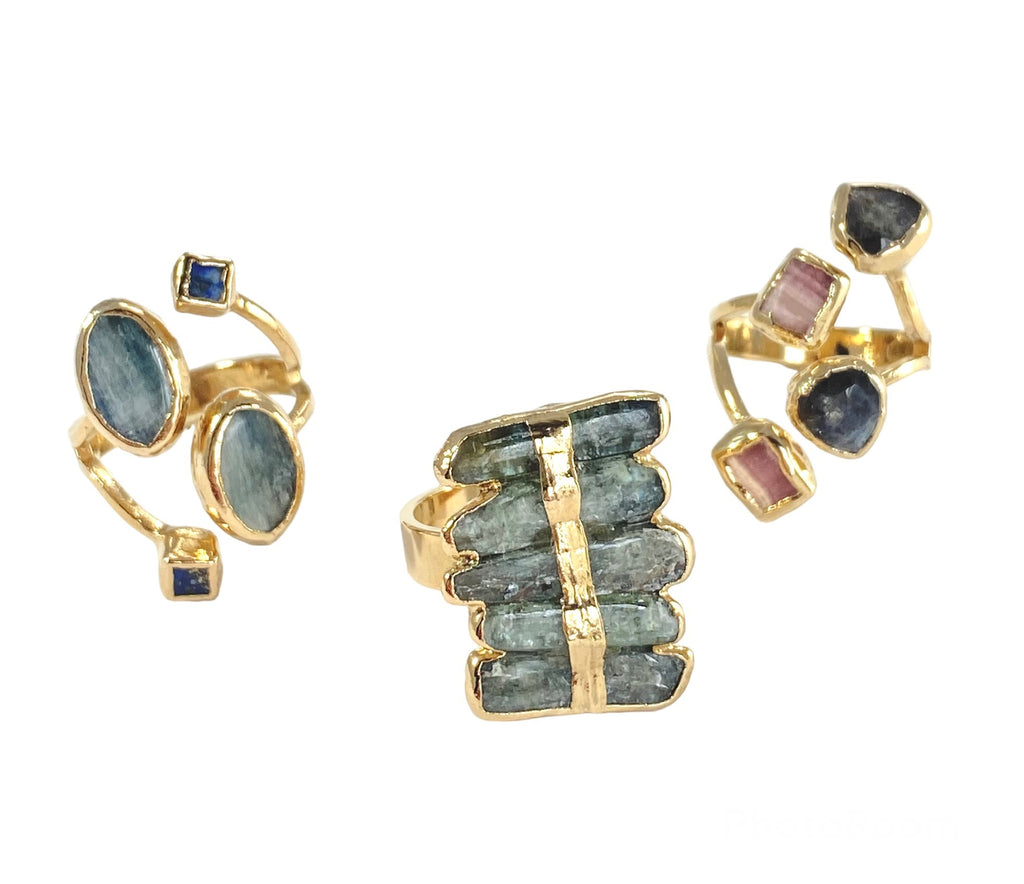 Elevate your style with the unique Layla ring. Featuring elegant kyanite stacked stones, a hand-painted gold stripe, and one-of-a-kind size and color variations. Add glamour and sophistication to any look with this stunning piece.