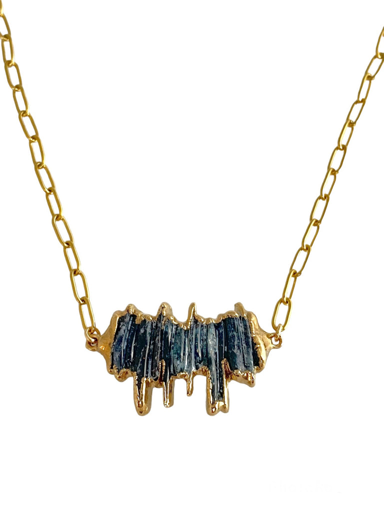 Unleash Edge with Aubrey Necklace. Stacked blue kyanite shard stones create a unique, eye-catching piece. Pendant measures 1.25 inch on a paperclip chain.