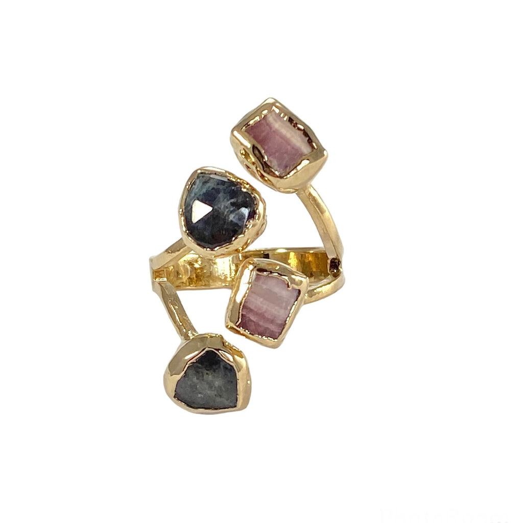 The Hazel ring, a versatile and stunning piece of jewelry, showcases four stones - Rhodochrosite and Labradorite. The stones, each measuring 1/4 inch in diameter, vary in color, shape, and size, adding to the ring's uniqueness. Its timeless design makes it a perfect accessory to complement any outfit.
