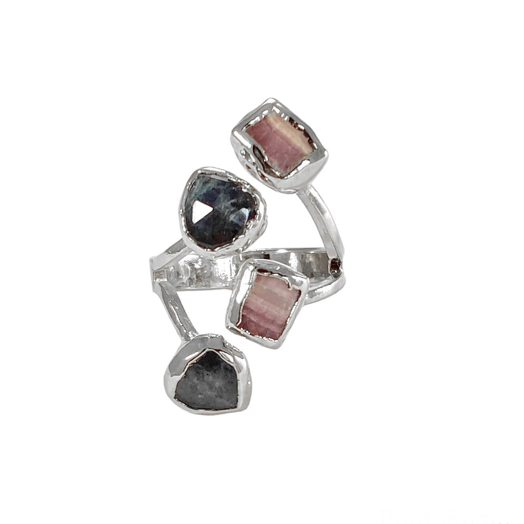 The Hazel ring, a versatile and stunning piece of jewelry, showcases four stones - Rhodochrosite and Labradorite. The stones, each measuring 1/4 inch in diameter, vary in color, shape, and size, adding to the ring's uniqueness. Its timeless design makes it a perfect accessory to complement any outfit.